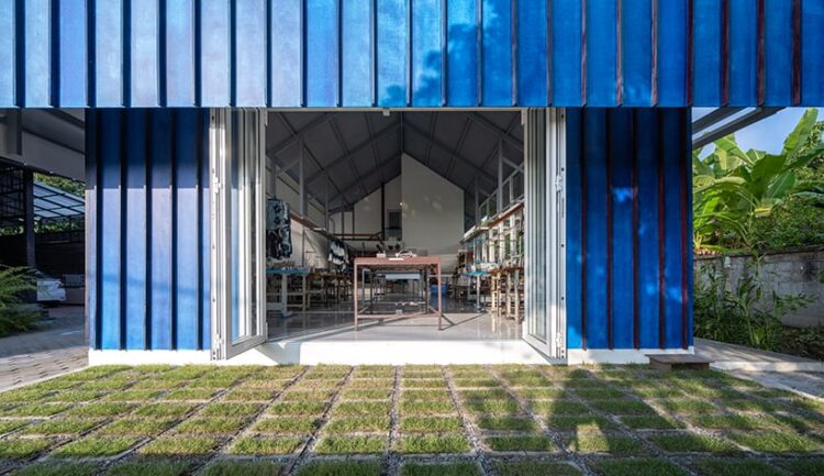 sher maker tops pleated wood longhouse with steel roof for fashion studio in chiang mai